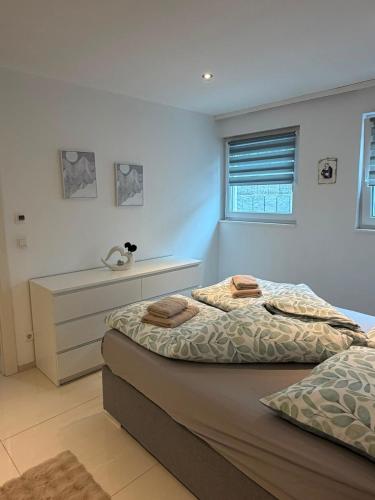 a bedroom with two beds and a window at Beautiful living in Schönaich