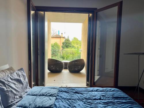 a bedroom with a bed and a sliding glass door at Little Venice in Sacile