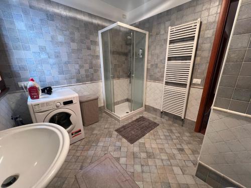 a bathroom with a shower and a washing machine at Little Venice in Sacile