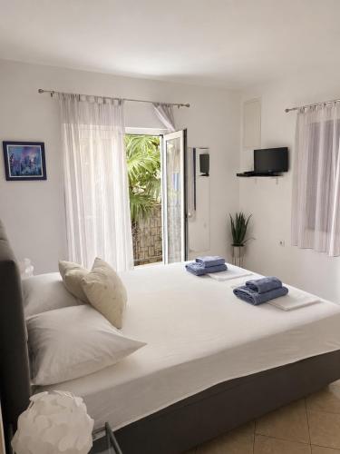 a bedroom with a large bed with two towels on it at Vila Marinessa in Hvar