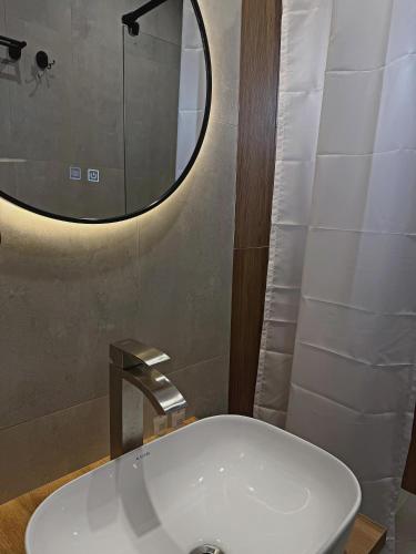 a bathroom with a white sink and a mirror at Jetel Boutique Hotel in Almaty