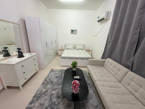 a small living room with a bed and a couch at المرور ابو ظبي in Abu Dhabi