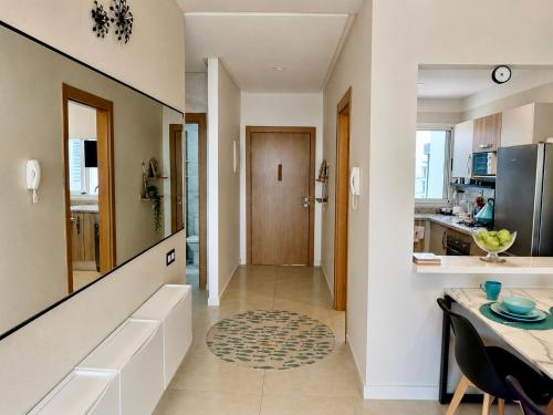 a kitchen and dining room with a dining table and a hallway at Ocean Therapy in Dar Oulad Hajj Kassem