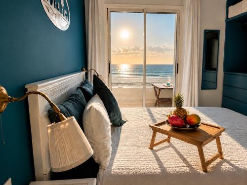 a bedroom with a bed with a view of the ocean at Ocean Therapy in Dar Oulad Hajj Kassem
