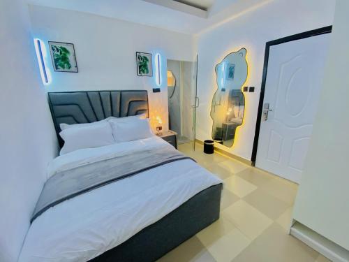 a bedroom with a large white bed in a room at The Royal Enclave in Abuja