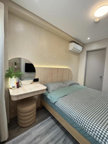 a bedroom with a bed and a sink at J-Stays 2BR Beach Condo at Seafront Residences in San Juan