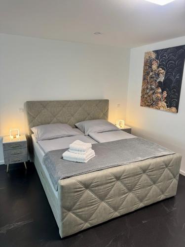 a bedroom with a bed with two towels on it at Erdeis Apartments in Krems an der Donau