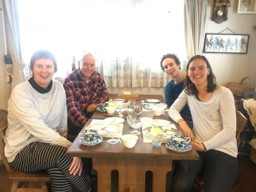a group of people sitting around a wooden table at Fujiyoshi in Nozawa Onsen