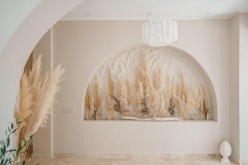 a room with a painting on the wall and a chandelier at AMAREA BOUTIQUE Hotel in Eforie Sud