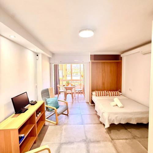 a living room with a bed and a couch and a table at Hercules in Arroyo de la Miel