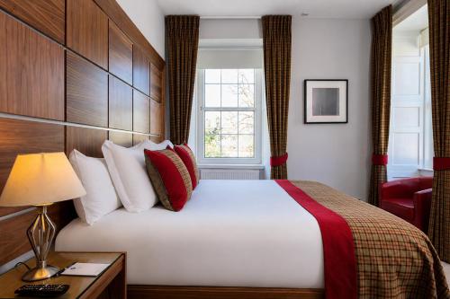 a hotel room with a bed and a window at The Glenmoriston Townhouse Hotel in Inverness
