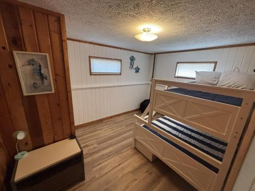 a small room with two bunk beds in it at Trailside Lake Retreat in Gaylord