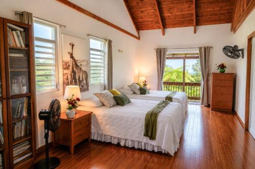 a bedroom with a bed in a room with windows at New Mountain Escape Panoramic San Juan Views in Aguas Buenas