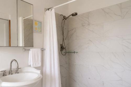 a bathroom with a white shower curtain and a sink at New Mountain Escape Panoramic San Juan Views in Aguas Buenas