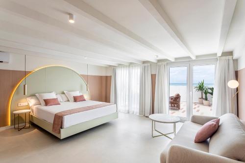 a hotel room with a bed and a couch at Blue Malva in Valencia