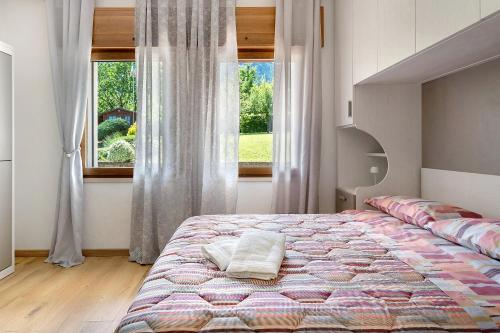a bedroom with a large bed in front of a window at Casa Aria Pura in Alano di Piave