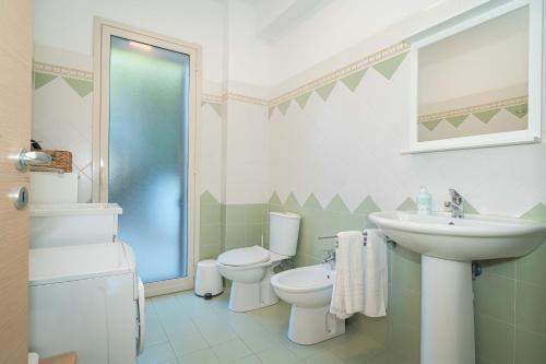 a bathroom with a sink and a toilet at New Naxian Holidays in Giardini Naxos