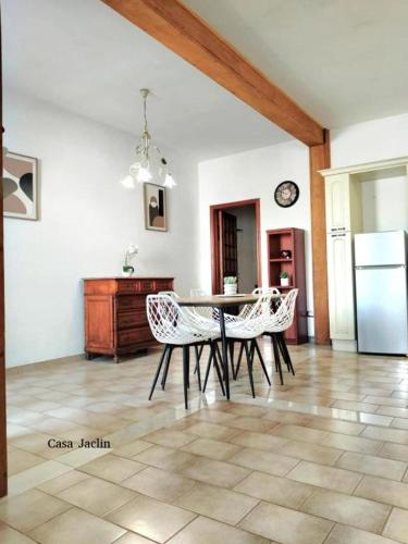 a kitchen with a table and chairs and a refrigerator at Appartamento Mancaversa Centro, 200m mare in Marina di Mancaversa