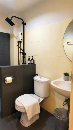 a bathroom with a toilet and a sink at La Vie Résidence in Chiang Mai