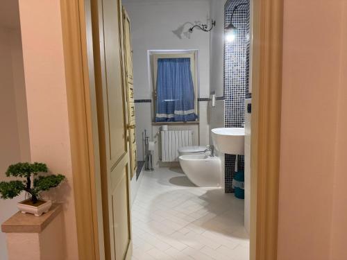 a bathroom with a white toilet and a sink at Casa Alessandra in Arezzo