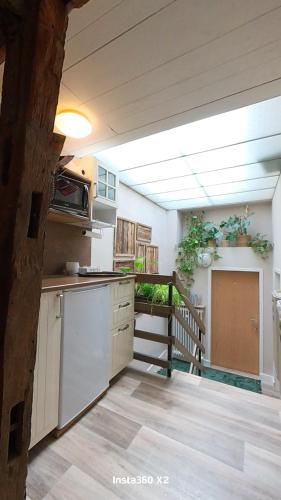 a kitchen with white cabinets and a balcony at Pension Martin Zimmer & Apartment in Bad Camberg