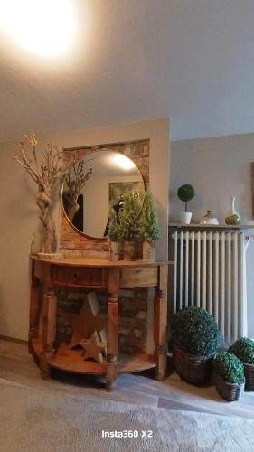 a mirror sitting on top of a wooden table at Pension Martin Zimmer & Apartment in Bad Camberg