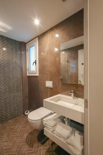 a bathroom with a toilet and a sink at The Real Sea View Hotel Vlore in Vlorë