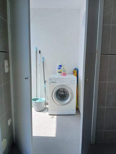 a bathroom with a washing machine in a room at Casa Estradinha Azul in Amarante