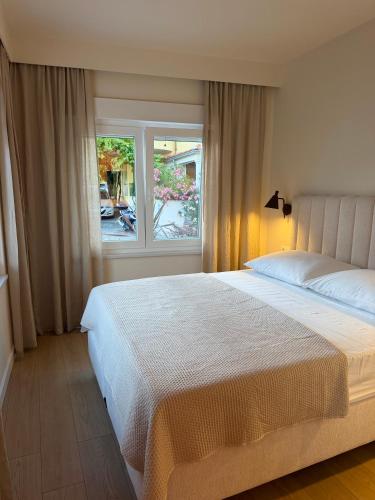 a bedroom with a large bed and a window at Apartments & Studios Dalmatino in Vodice