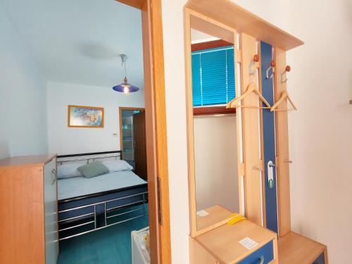 a small room with a bunk bed and a mirror at Rooms Čehovin in Postojna