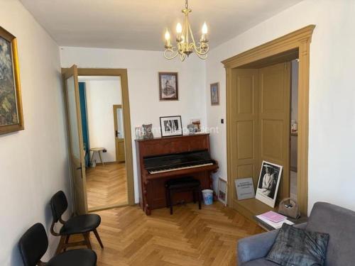 a living room with a piano and a couch at Downtown luxury segment in Braşov