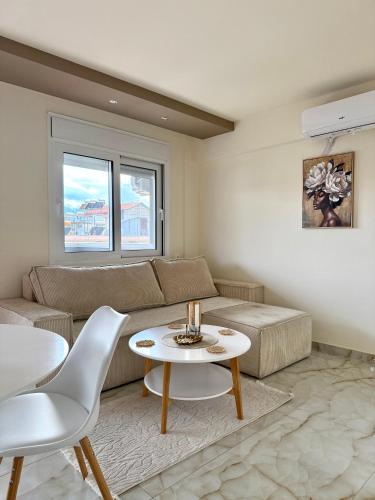 a living room with a couch and a table at Malama Rooms in Paralia Katerinis