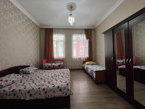 a bedroom with two beds and a mirror at Resort In Gonio in Kvariati