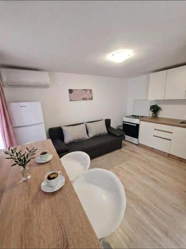 a living room with a table and chairs and a couch at C&M Studio Apartment in Rijeka