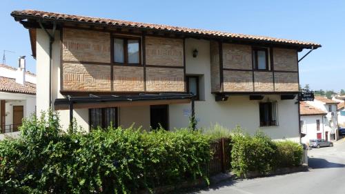 a house with a fence in front of it at Pasaje San Jorge in Comillas