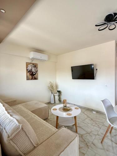 a living room with a couch and a table at Malama Rooms in Paralia Katerinis