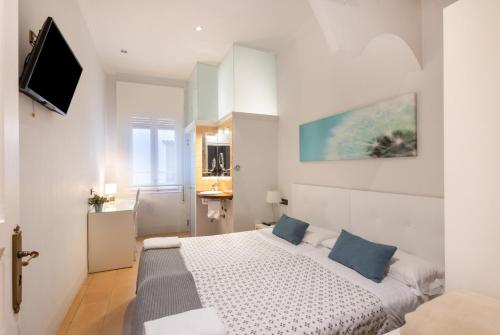 a bedroom with a large bed with blue pillows at Can Lluís in Capellades