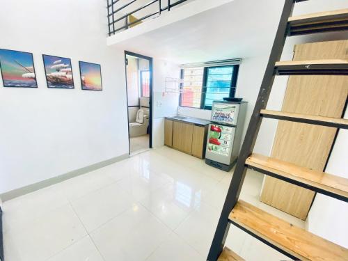 a room with a staircase leading to a kitchen at 46 An Hòa, Mỗ lao in Hanoi