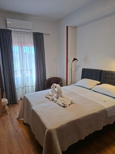 a bedroom with a bed with a towel on it at Apartments and Rooms "Almira" in Pula