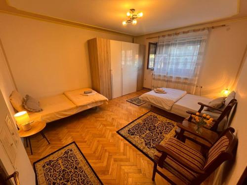 a room with two beds and a couch in it at Apartman 23 in Kraljevo