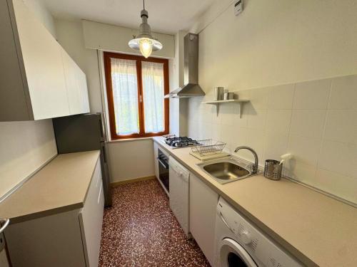 a small kitchen with a sink and a stove at Villa Lilly in Grado
