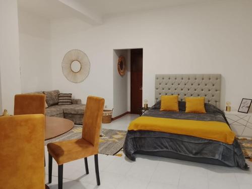 a bedroom with a large bed and a couch at Garça-Real 1 in Vale de Madeiros