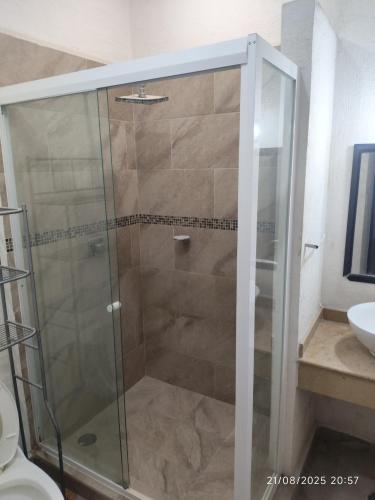 a shower with a glass door in a bathroom at casa confortabla y relajante con alberca y laguna in Monterrey