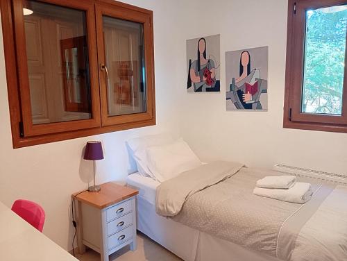 a small bedroom with a bed and a window at Stamoulis Garden House in Katigiorgis
