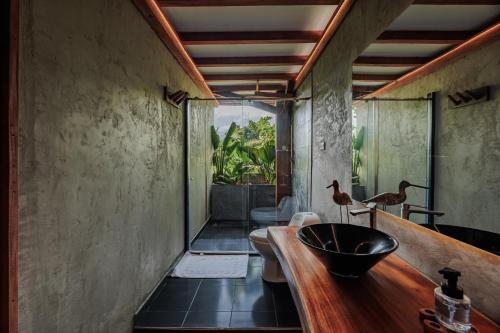 a bathroom with a sink and a toilet and a tub at Jaguar Beachfront Ecohotel & Spa in Santa Marta