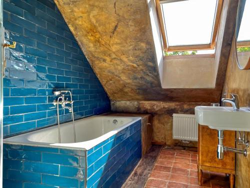 a bathroom with a bath tub and a sink at Apartmány Za branou in Kutná Hora