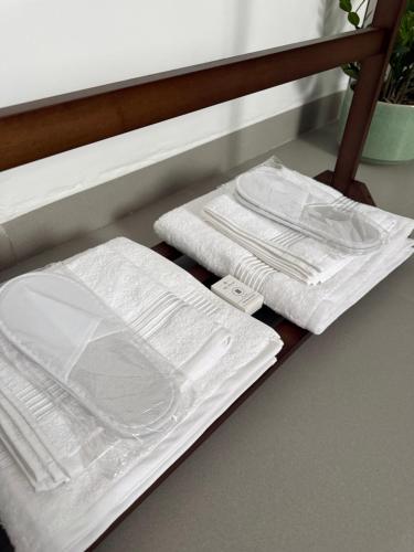 a shelf with white plates and towels on it at Ghosen Al Zaitoon chalet in Sayq