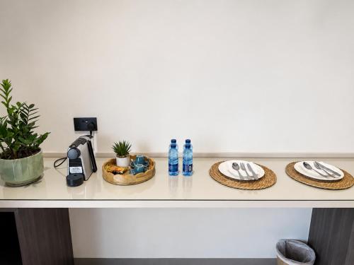 a table with plates and water bottles on it at Ghosen Al Zaitoon chalet in Sayq