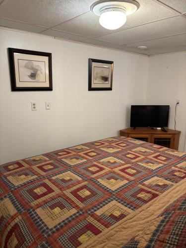 a bedroom with a bed with a quilt on it at Oasis Studio in Cambridge