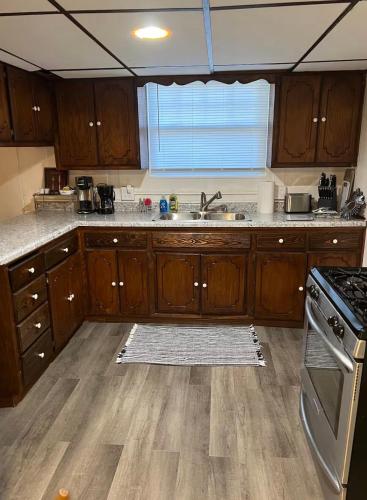 a kitchen with wooden cabinets and a sink at Oasis Studio in Cambridge